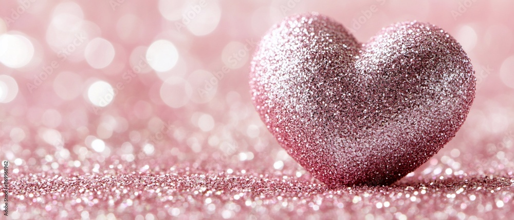 Fototapeta premium Glittery pink heart on sparkly background.