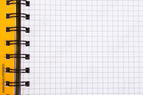 an open yellow notebook with checkered leaves and a place for text