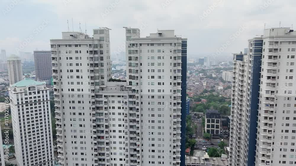 A sleek drone gracefully navigates through the concrete jungle of Jakarta, flitting between imposing skyscrapers. The bird's eye perspective is awesome. A sleek drone gracefully navigates through the concrete jungle of Jakarta, flitting between imposing skyscrapers. The bird's eye perspective is awesome.