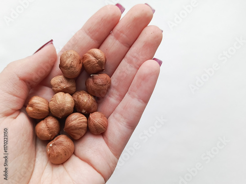 Hazelnuts in a woman's hand. Hazelnuts in the diet. Snack. Vegetable proteins, fats. photo