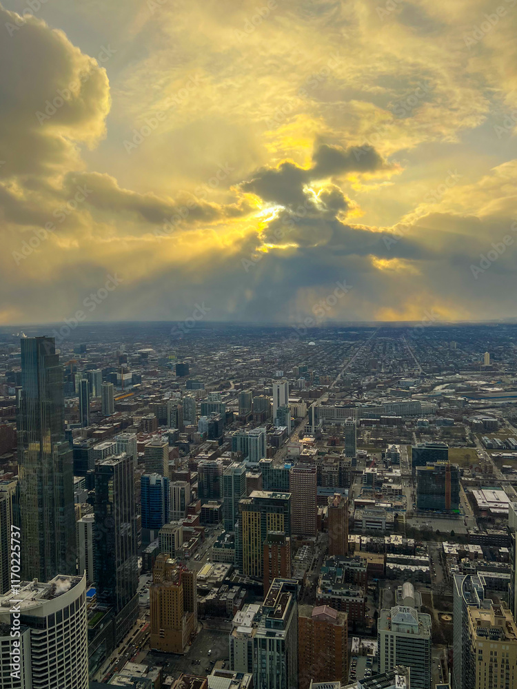 Fototapeta premium Dramatic Sunset Over City Skyline with Sun Rays