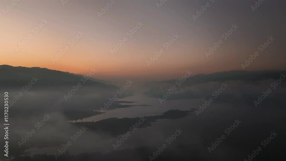 Lake and mountains at dawn under mist, clean energy metaphor Lake and mountains at dawn under mist, clean energy metaphor