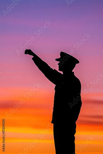 Silhouetted soldier standing solemnly at sunset, symbolizing dedication and sacrifice photo