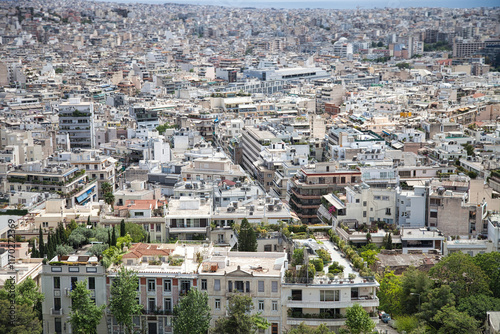 Fototapeta Naklejka Na Ścianę i Meble -  A panoramic view of Athens, Greece, showcasing the bustling urban landscape with a blend of modern and traditional architecture. The densely packed buildings stretch into the distance