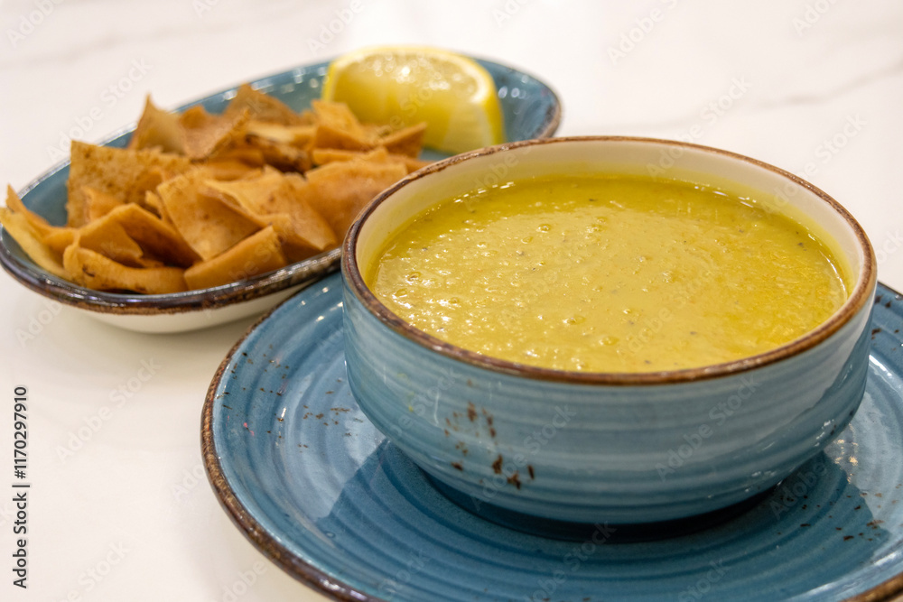 Turkish lentil soup with lemon slice and cracker Turkish lentil soup with lemon slice and cracker
