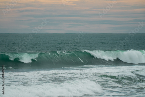 waves breaking on the beach. Ocean waves breaking on a  beach. Close up shot of breaking wave Pandansari beach, Central Java, Indonesia. photo