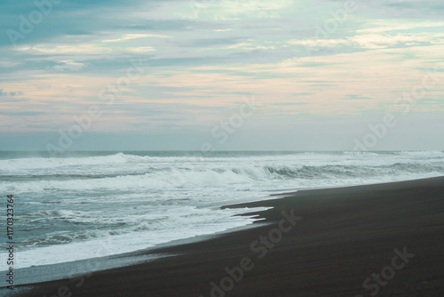 waves breaking on the beach. Ocean waves breaking on a  beach. Close up shot of breaking wave Pandansari beach, Central Java, Indonesia. photo