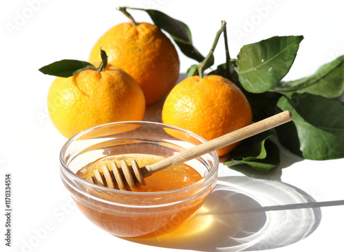 Fresh Tangerines with Leaves  and Honey bowl with Honey and Dipper isolated on white