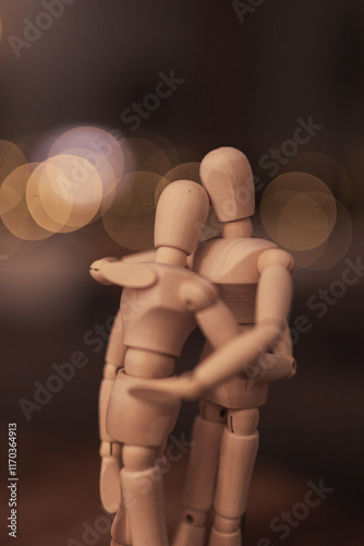 Close-up of two wooden dolls hugging each other