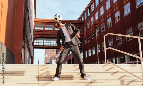 Businessman playing with a soccer ball and making freestyle tricks photo