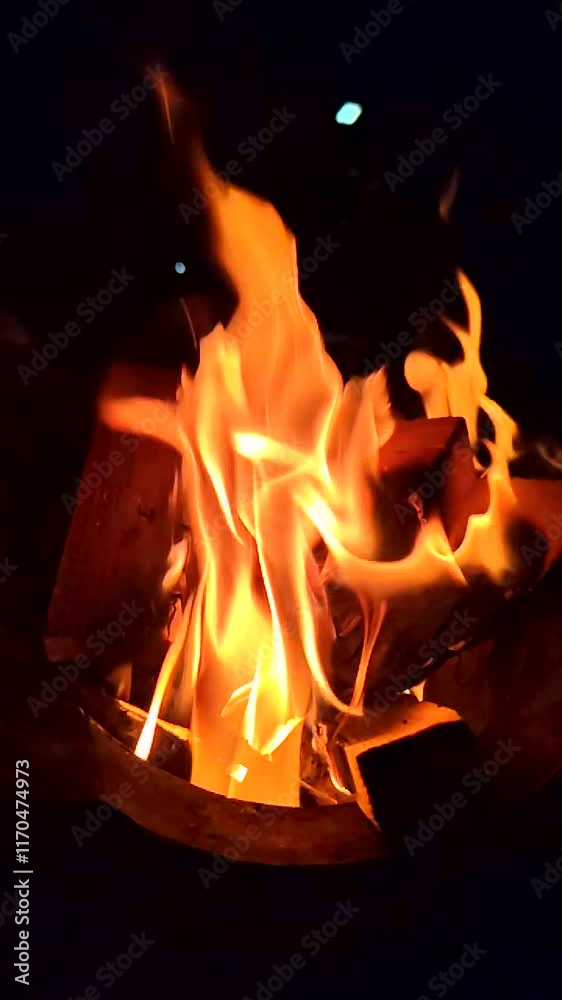 Camping fireplace with blazing flames and glowing coals Camping fireplace with blazing flames and glowing coals