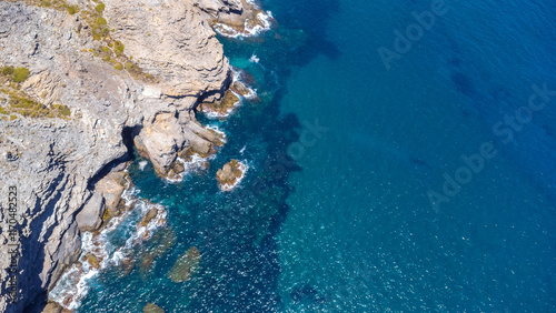 Drone capturing stunning cliffs and turquoise mediterranean sea in la manga photo