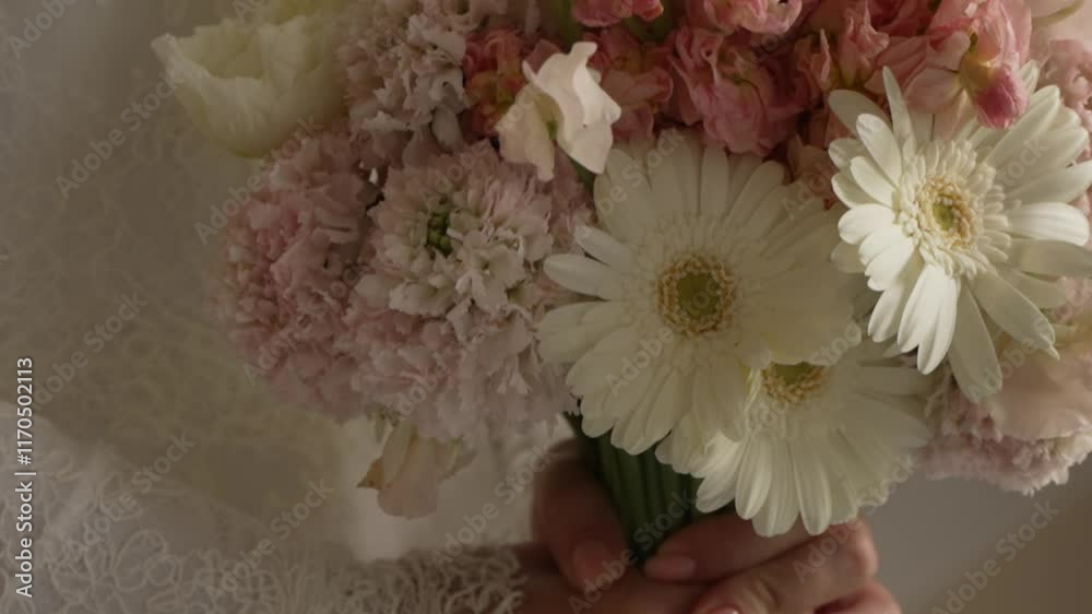 Close-Up of a Bride Holding a Bouquet of Pink and White Flowers in Lace Sleeves. Detailed shot of a bride's hands holding a delicate bouquet with pink and white flowers. Perfect for wedding promotions Close-Up of a Bride Holding a Bouquet of Pink and White Flowers in Lace Sleeves. Detailed shot of a bride's hands holding a delicate bouquet with pink and white flowers. Perfect for wedding promotions