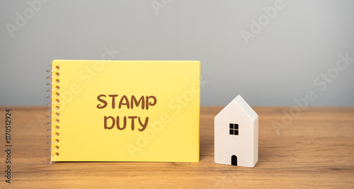 Stamp duty concept. Taxes assessed during the transfer of real estate between two parties. Buying housing and land. Property. Stamp Duty Land Tax SDLT. Notes bag and house photo