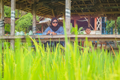 Asian Child play and learn about natural in planted rice, select focus photo