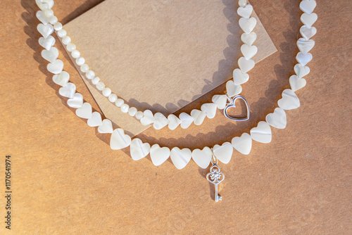 Gemstone necklace made of mother of pearls in shape of hearts.