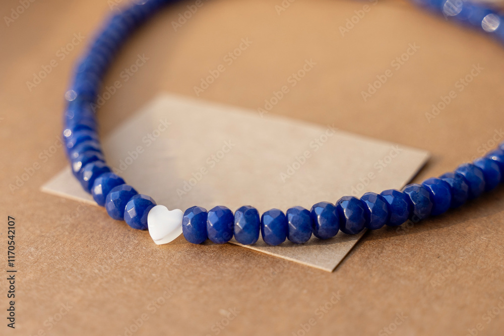 Gemstone necklace made of mother of pearls in shape of hearts.