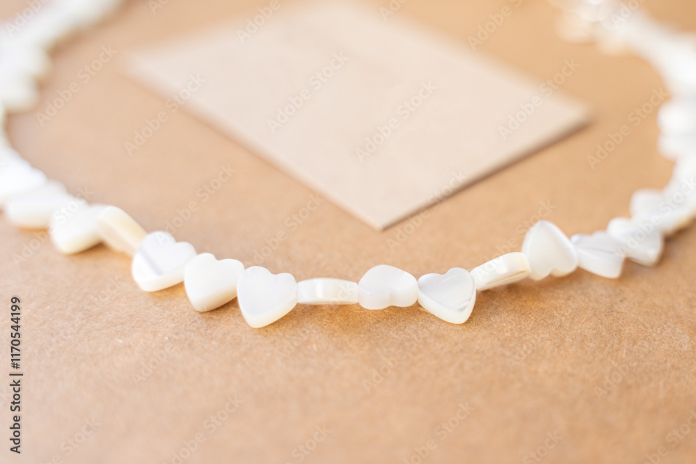 Gemstone necklace made of mother of pearls in shape of hearts.