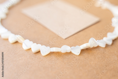 Gemstone necklace made of mother of pearls in shape of hearts.