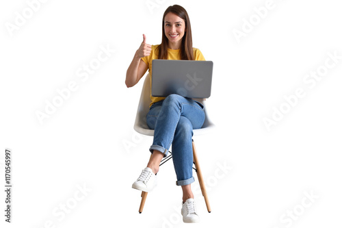 smiling woman in casual jeans and a yellow shirt, seated on a modern chair with a laptop