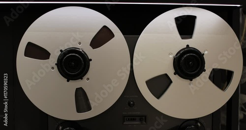 Reel to reel tape recorder playing. Rotating retro tape. Vintage music player close up. Old school concept.