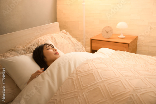 Woman falling asleep with indirect lighting Image of bed sleep and restful sleep Wide angle photo