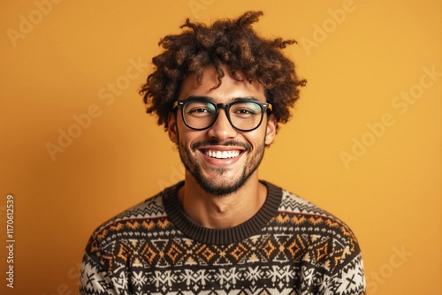 Smiling man wearing glasses and a patterned sweater, set against a vibrant orange background. Warm and friendly atmosphere. Ai generative photo