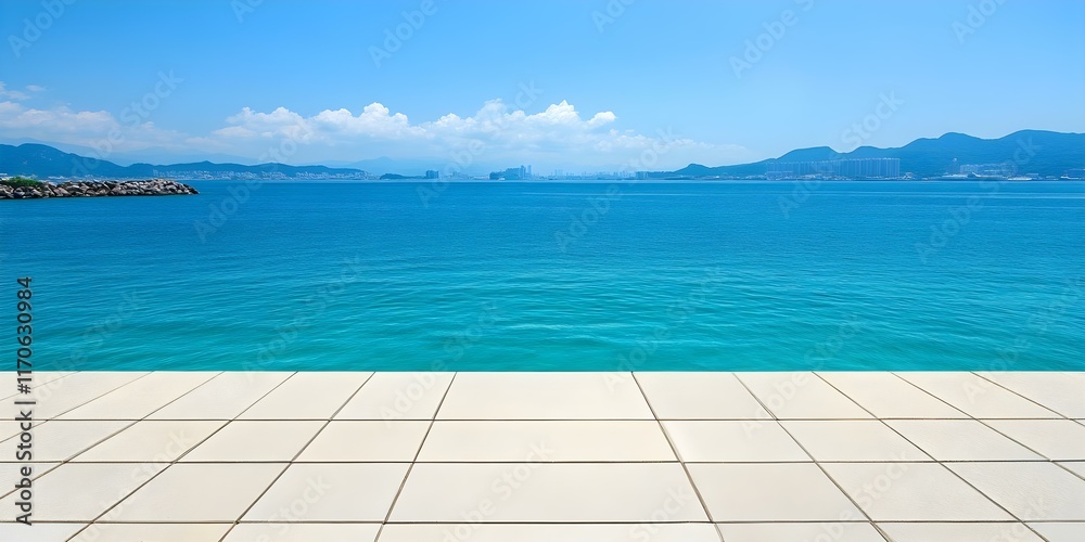 Fototapeta premium A clear blue ocean extends to distant mountains under a bright sky, with a tiled surface in the foreground. Concept Serene Ocean View, Distant Mountains, Bright Sky, Tiled Foreground