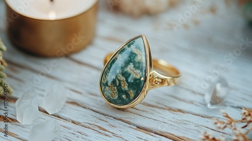 Gold Moss Agate Ring on Textured Wooden Surface photo