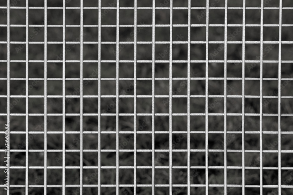 Fototapeta premium metal grille on grey background close up