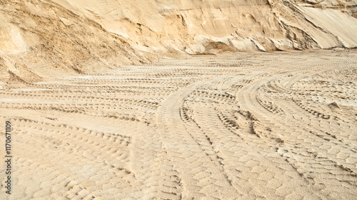 Excavator wheel marks in a sand quarry