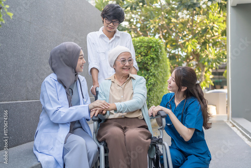 senior woman cancer patient on wheelchair,family,health care workers supporting,talking and empowering while resting outdoors in hospital