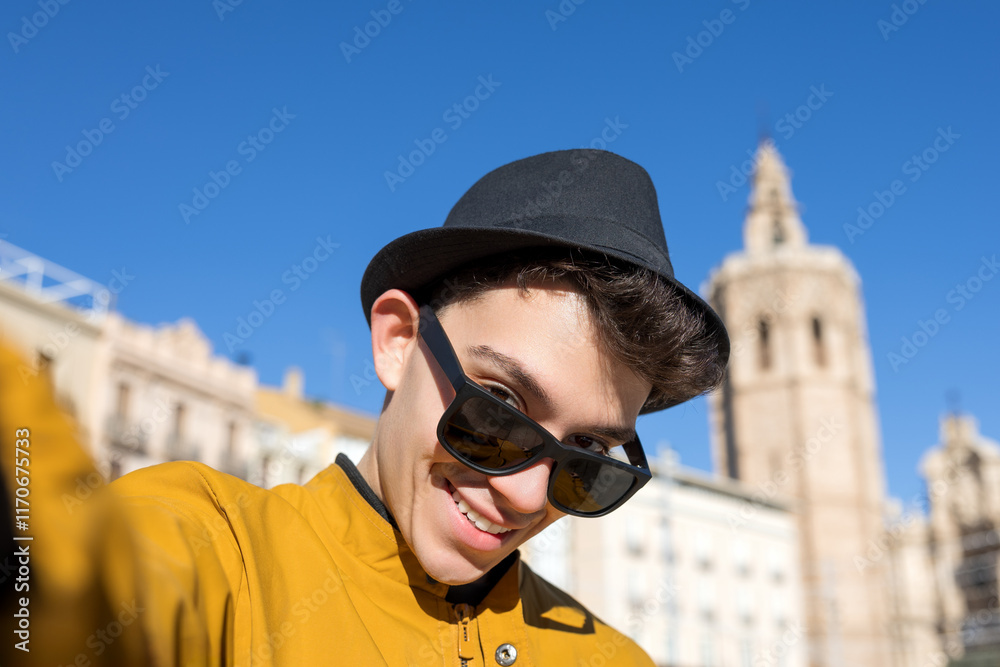 Young man taking a playful selfie during his vacation on a sunny day Young man taking a playful selfie during his vacation on a sunny day