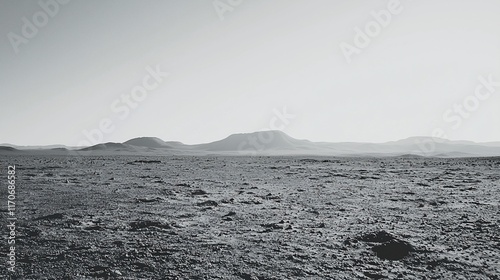 Monochromatic landscape of a vast, desolate desert plain under a pale sky, featuring low-lying hills in the distance.