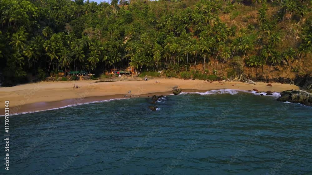 Aerial drone shot of Kakolem Beach in Goa, showcasing its unspoiled beauty at sunset. Aerial drone shot of Kakolem Beach in Goa, showcasing its unspoiled beauty at sunset.