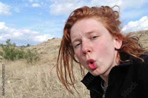 Redhead boy puckering his lips