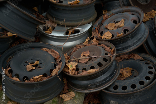 A sad mountain of old rusty wheel rims