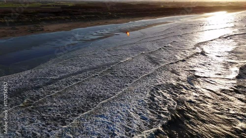 Kiteboarding adventure at sunset along the scenic shoreline