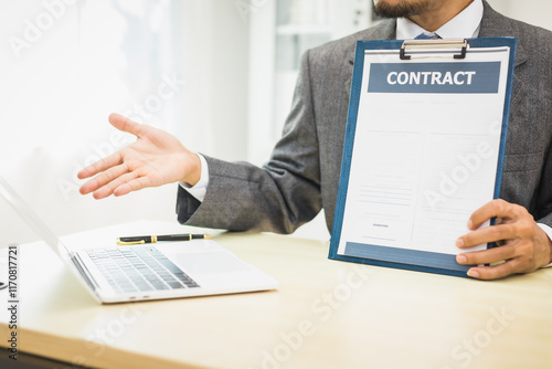 Male lawyer diligently examines documents placed on his desk, demonstrating his professionalism and dedication to finding legal truth, analyzing ideas, and pursuing justice with relentless focus. photo