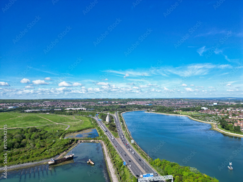 Naklejka premium Portsmouth City Located at Beach and Sea Front Port Docks of England’s south coast, United Kingdom. Aerial Footage Was Captured with Drone's Camera on May 15th, 2024.