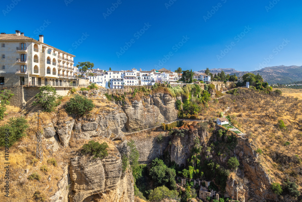 Ronda town in Spain. Whitewashed village perched atop dramatic cliffs, a stunning view of Andalusian architecture and landscape. Ronda town in Spain. Whitewashed village perched atop dramatic cliffs, a stunning view of Andalusian architecture and landscape.