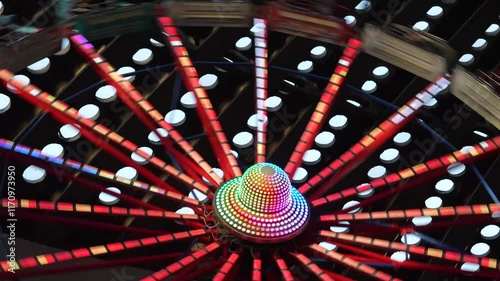 Carnival thrill spinning amusement park fast speed ride wheel close up