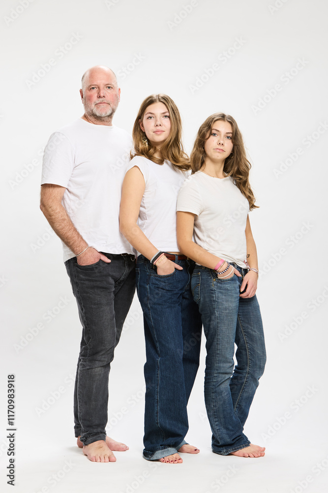 Studio portrait of father with two teenage kids. Studio portrait of father with two teenage kids.