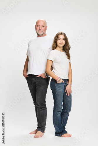 Studio portrait of father with two teenage kids.