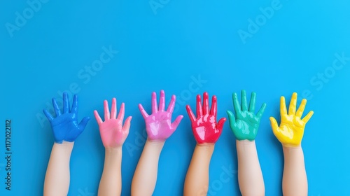 Colorful Handprints: A vibrant and playful arrangement of colorful handprints on a bright blue background, symbolizing creativity, childhood innocence, and the power of expression.