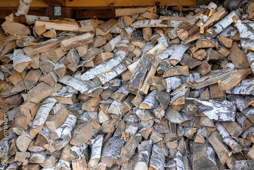 A large stack of birch wood. A rural lifestyle.