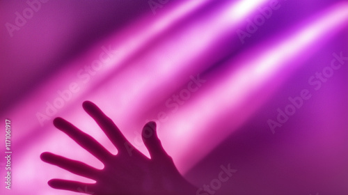 Hand touching bright pink and purple light beams