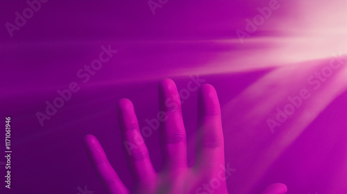 Hand reaching for bright light beams on purple background