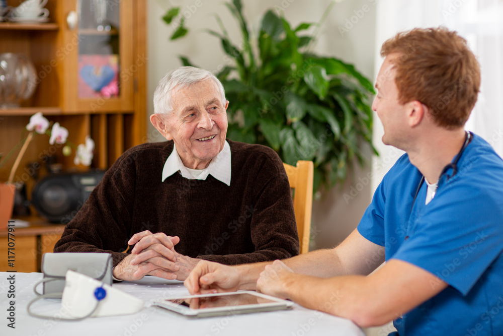 The healthcare professional in blue scrubs performing a health check on an elderly man in a comfortable indoor environment of a care home