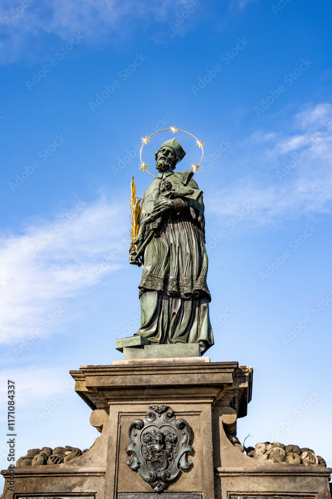 Bronze statue of Saint John of Nepomuk outdoor sculpture by sculptor Jan Brokoff on Charles Bridge, Prague, Czech Republic Bronze statue of Saint John of Nepomuk outdoor sculpture by sculptor Jan Brokoff on Charles Bridge, Prague, Czech Republic